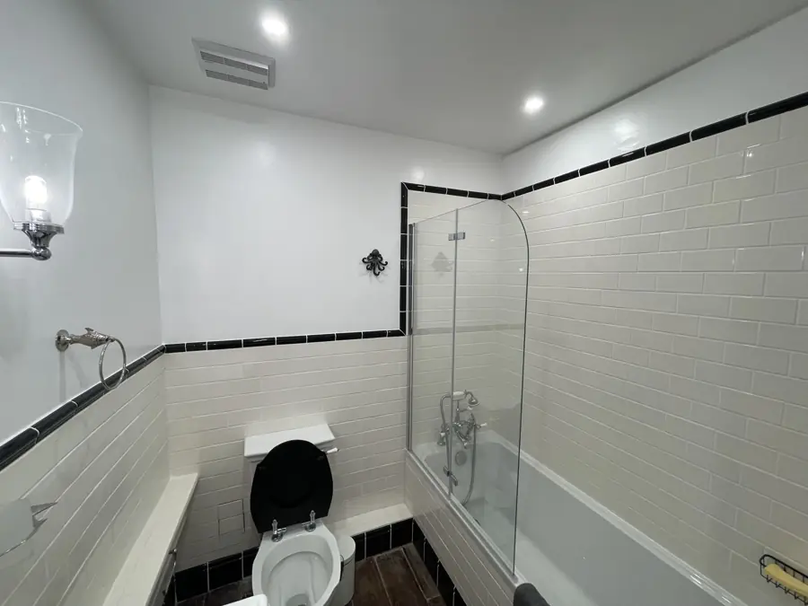 Bath with glass screen and metro tiles