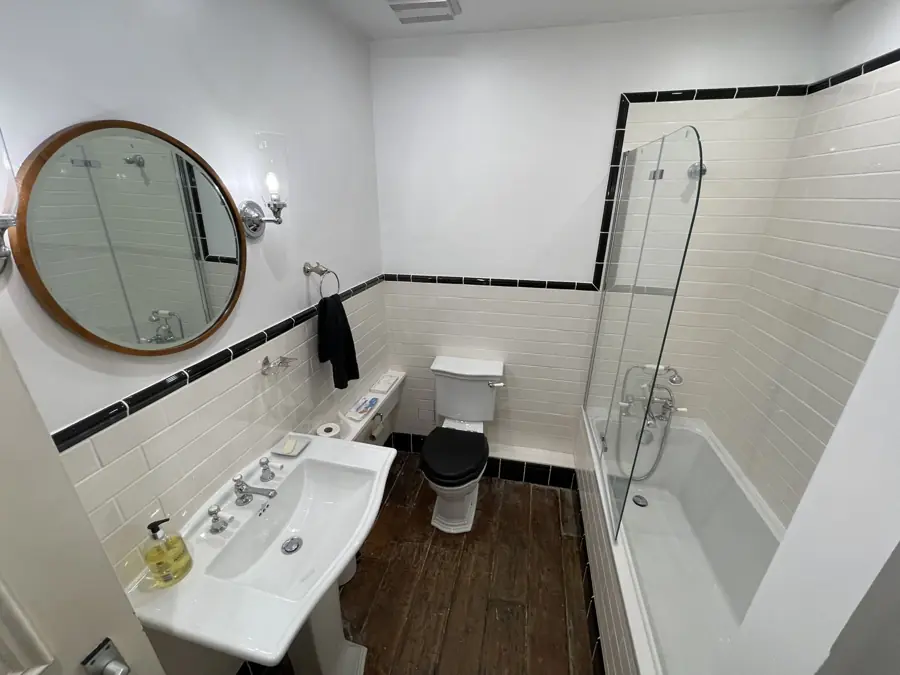Basin, round mirror and wall light