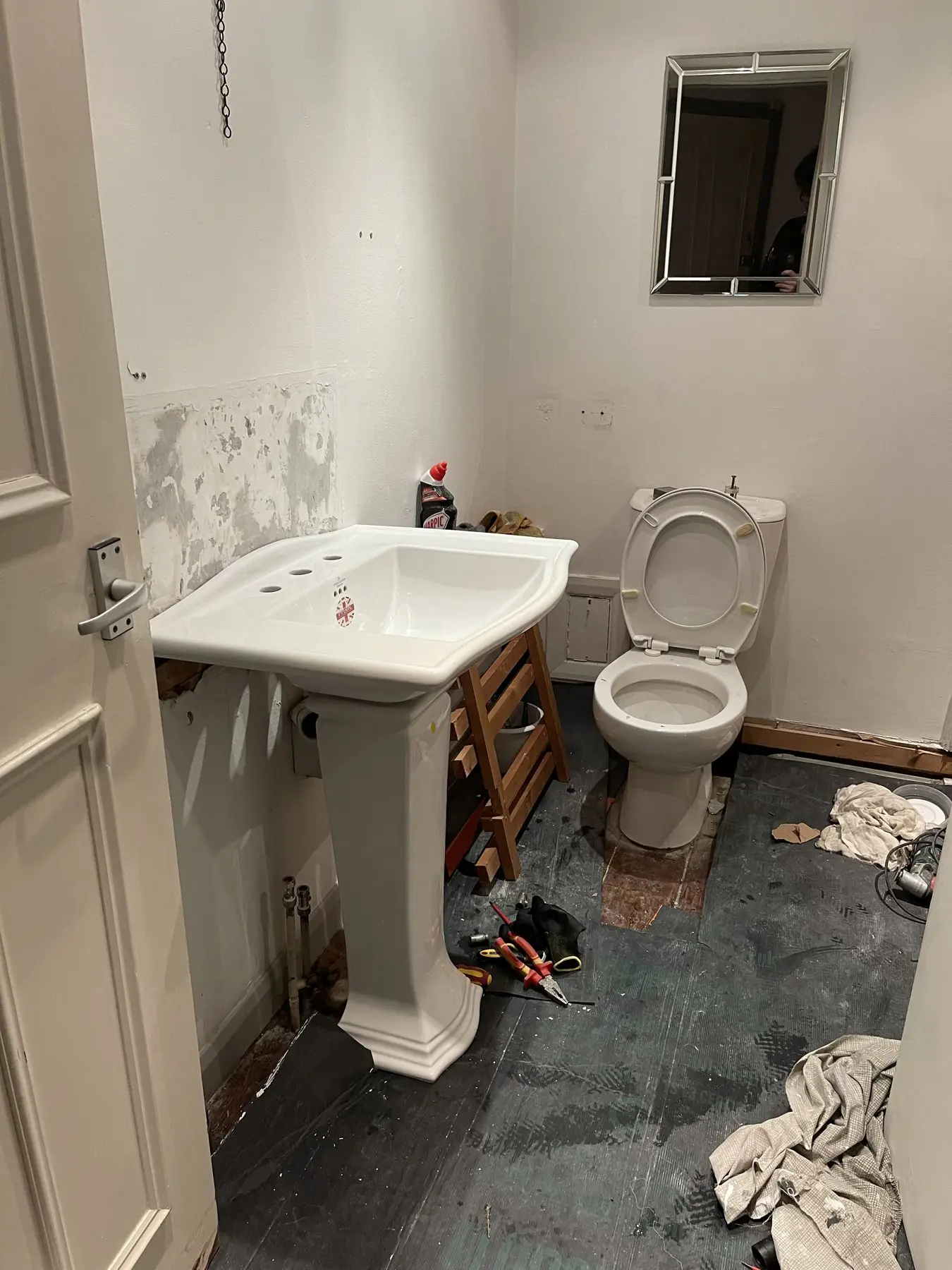 Bathroom before: stripped back with old suite