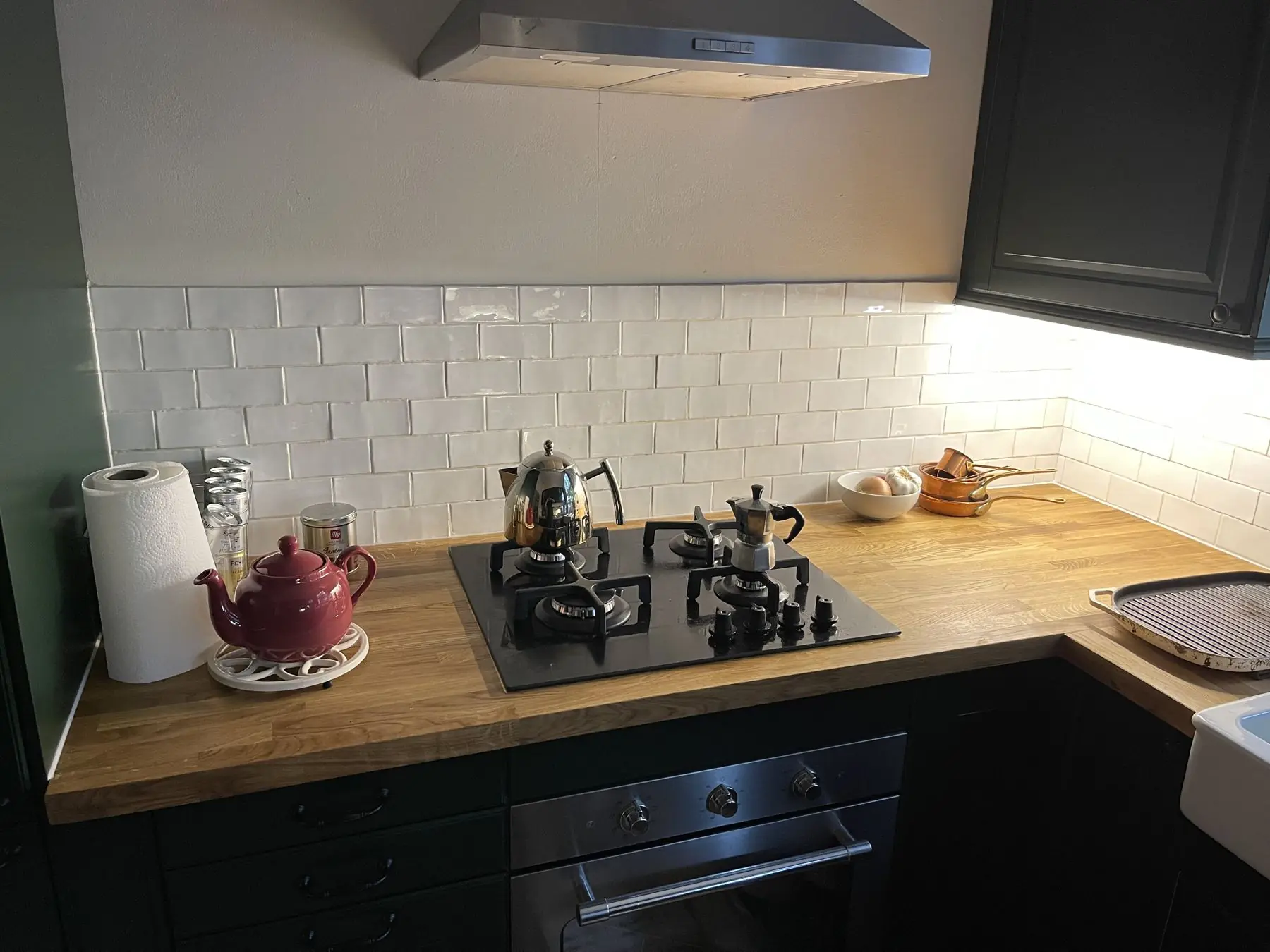 Green shaker kitchen with oak worktops, fitted by Aveiro
