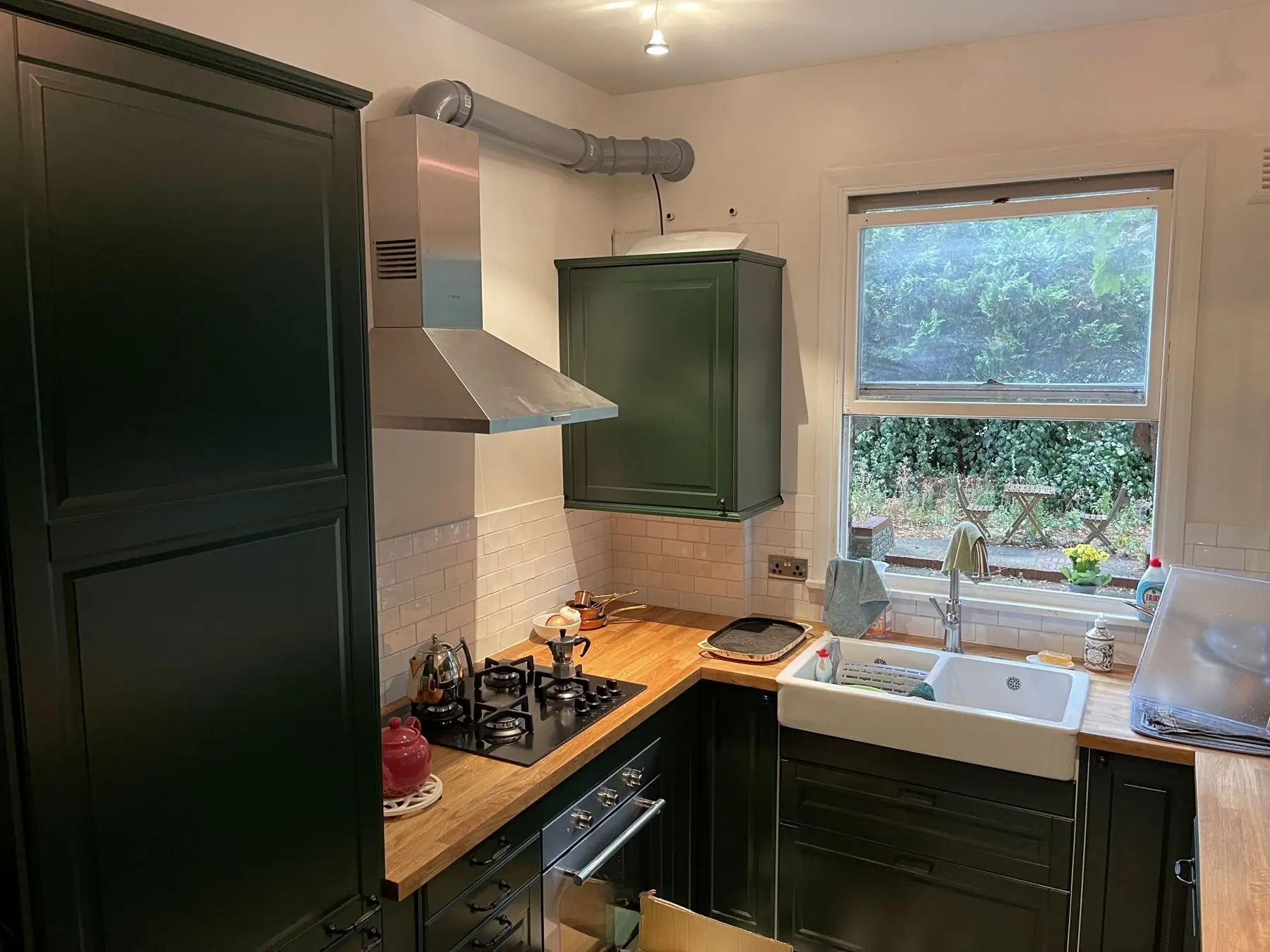 Green shaker kitchen with oak worktops